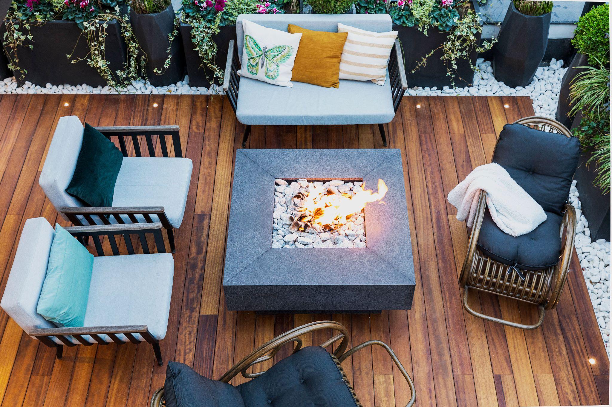 OutVue fire pit burning on an outdoor wood deck